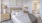 a bedroom with a bed and lamps