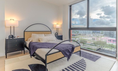 a bedroom with a large window