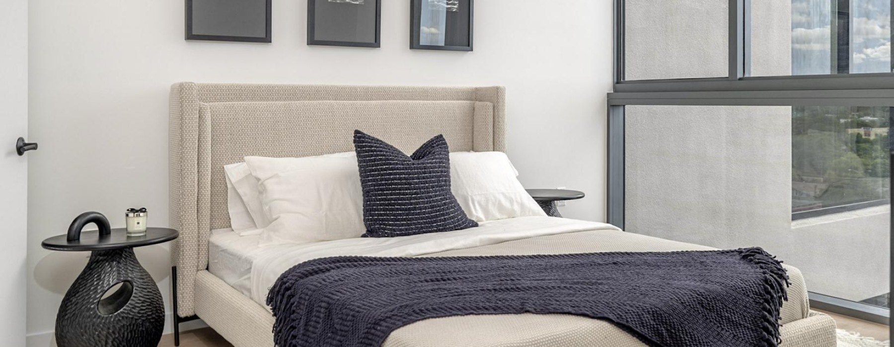 a bed with a black and white striped blanket